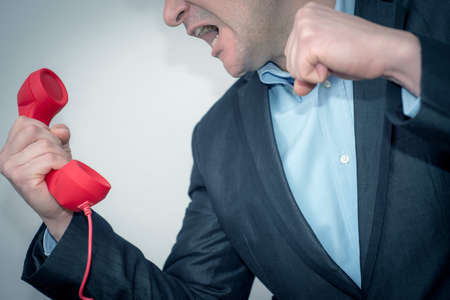 Young businessman with the phone,angry-violent.
The Boss informs him that he did a good jobの写真素材