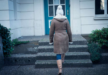 A young woman is ascending - go up on the steps.A young woman is willing to go home. On the front...