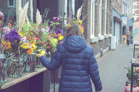 Young smiling woman selecting fresh flowers 
の写真素材