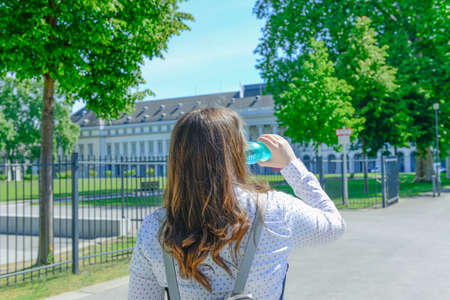 Hydration concept. A young business woman drinking a bottle of waterの写真素材