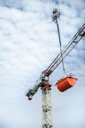Crane transport debris and wood rests from a concrete structure buildingの写真素材
