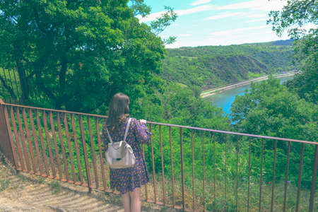 Summer sunny lifestyle fashion portrait of young stylish hipster woman walking in mountains,...