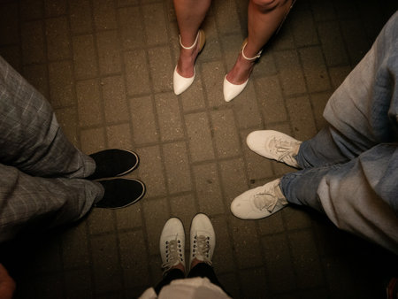 Closeup legs of a group of people standing on the street. top viewの写真素材