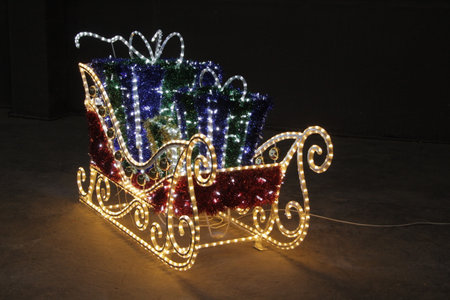 christmas decoration in the form of a sleigh with gifts and lightsの写真素材