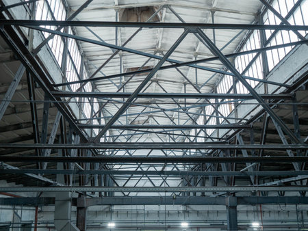 Interior of large industrial hall with metal roof trussesの写真素材