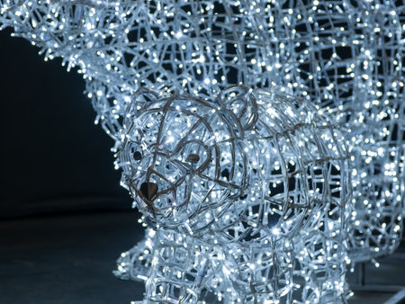 Christmas tree made of silver garland lights on a black background.の写真素材