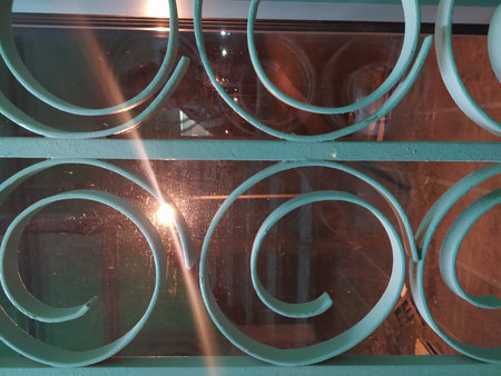 Decorative metal lattice in the shape of a circle on a window