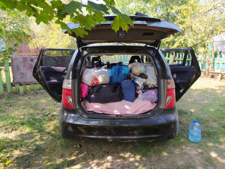 Open trunk of car full of luggage in countryside. Summer vacation conceptの写真素材