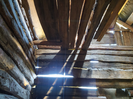 Interior of an old wooden barn with a beam of light.の写真素材
