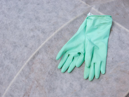 Green rubber glovesle background. Housework and housekeeping concept.の写真素材