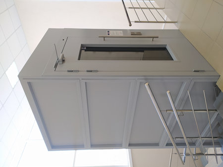 Metal elevator for transporting people with disabilities in the interior of the building