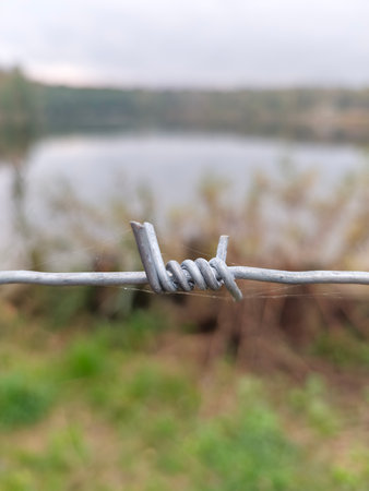 barbed wire on the background of the river, close-upの写真素材