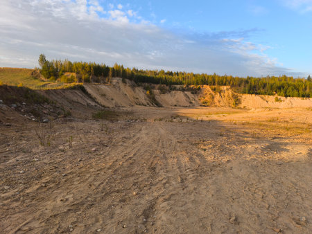 sand quarry in the evening. Landscape with sand, trees and blue skyの写真素材