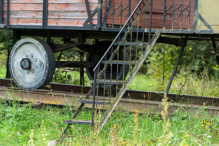 Old rusty train carriage on rails in the countryside, close-upの写真素材
