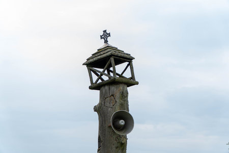 A wooden pole with a Christian cross and a megaphone.の写真素材