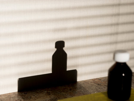 Shadow of a bottle of medicine on the table. Shallow DOFの写真素材