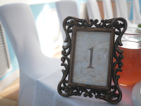 Vintage photo frame with number one on the table in the restaurantの写真素材