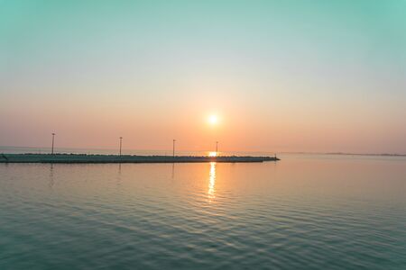 Golden sunrise sunset over the seaの写真素材