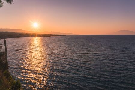 Golden sunrise sunset over the sea wavesの写真素材