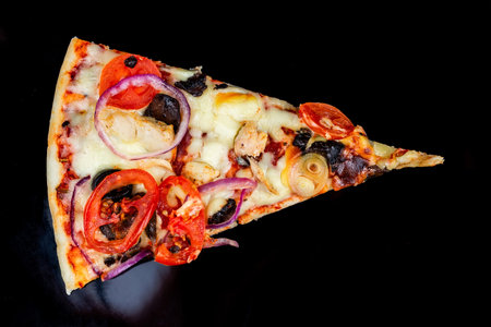 Delicious pepperoni pizza and basil tomato ingredients on a black concrete background. Top view of hot pepperoni pizza. With space for copying text. The apartment was lying there. Banner adの写真素材