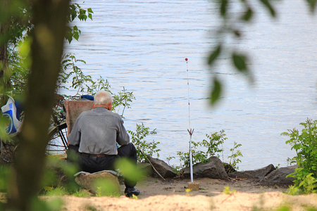 the old man is resting on a fishing tripの写真素材
