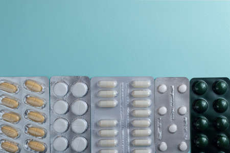 Pills and tablets on blue background