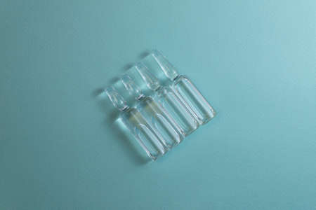 health care / medical concept: set of ampules in blue backgroundの写真素材