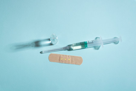 White, red and yellow pills on blue background with a hard shadowの写真素材