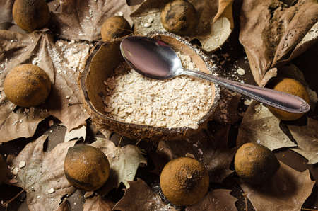 Oatmeal dish served in the middle of a dry coconut, garnished with dried and yellowish lemons, dried...