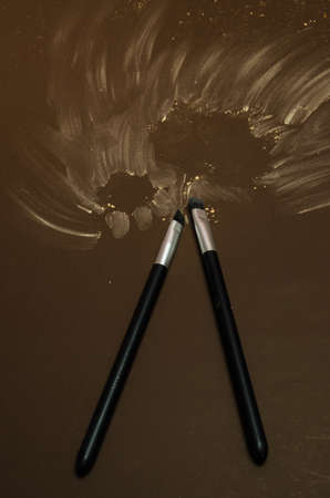 Kit of two make-up brushes with autumn seasonal theme, on a isolated colored coffee background,...
