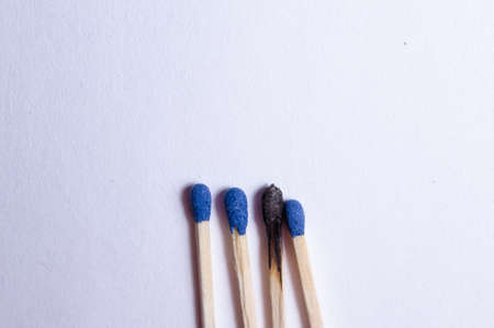 group of 4 matches and a burnt match, on a white background isolatedの写真素材