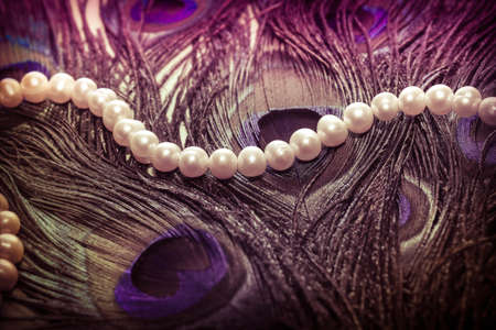 feather exotic bird peacock and the female necklace of pearlsの写真素材