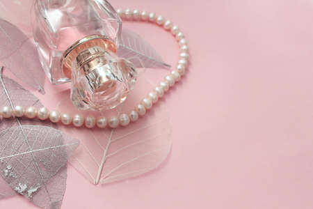 A bottles of female perfume on a gentle pink backgroundの写真素材