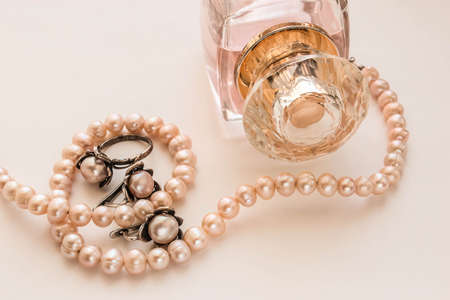 Transparent bottles of glass. Female perfume on a pink backgroundの写真素材