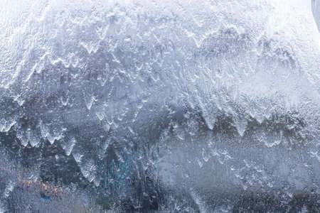 Cold background with flowing water vertically, liquid texture