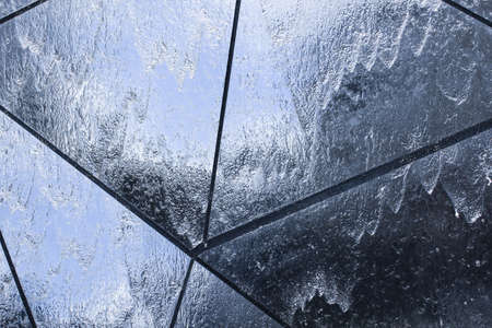 Water flows down the mirror wall, the texture of the transparent liquiの写真素材