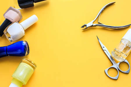 Manicure set beauty hands. Yellow backgroundの写真素材