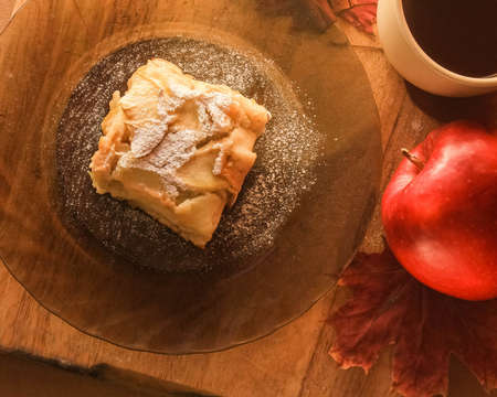 Cup of tea and a piece of apple pie on a plateの写真素材