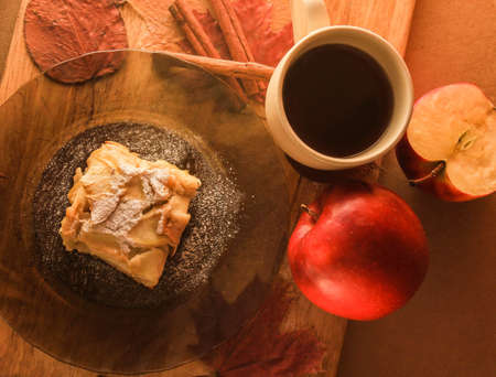 Cup of tea and a piece of apple pie on a plateの写真素材
