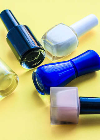 Set for nail care, manicure tools scissors, nippers, varnish on a yellow backgroundの写真素材