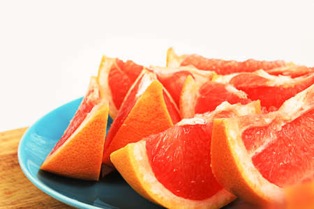 Orange tasty fruit grapefruit sliced ??on a plateの写真素材