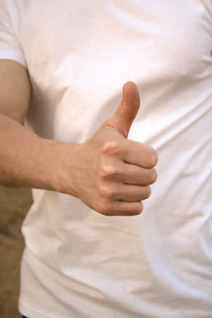 Guy shows a positive gesture, thumbの写真素材