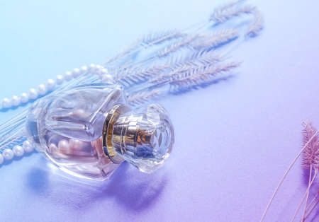 A bottle of female perfume on a gentle backgroundの写真素材