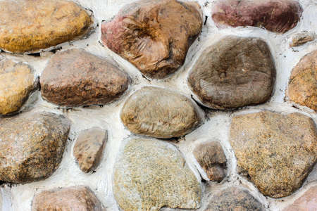 Texture of a round brown stone, part of a building, a fortressの写真素材