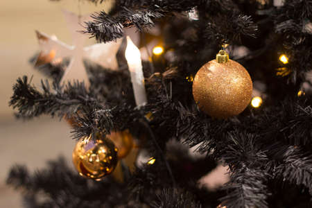 golden Christmas balls hanging on the tree, beautiful decoration for the new yearの写真素材
