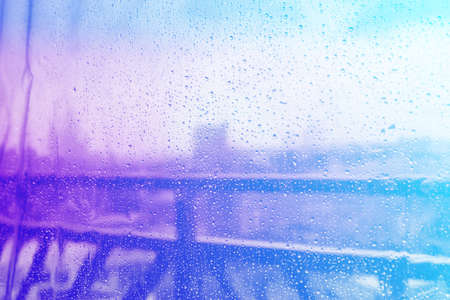Rain, water drop of rain on glass with outdoor backgroundの写真素材
