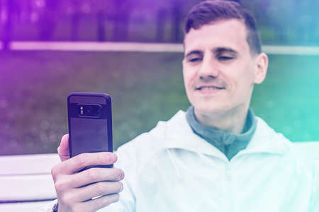 Picture of young man make a selfie by phone. Looking at phone.の写真素材