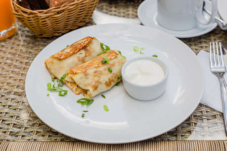 morning breakfast stuffed pancakes on a white plate, russian traditional foodの写真素材