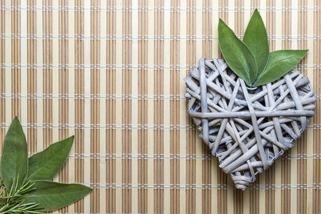 Wooden heart with sage leavesの写真素材