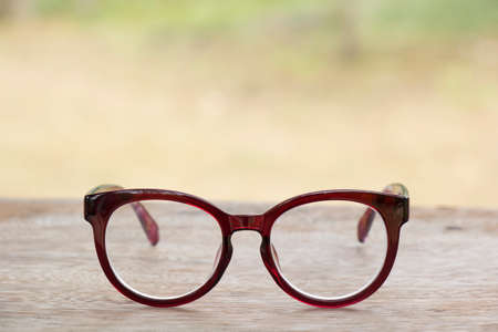 Red glasses on old  wood tableの写真素材
